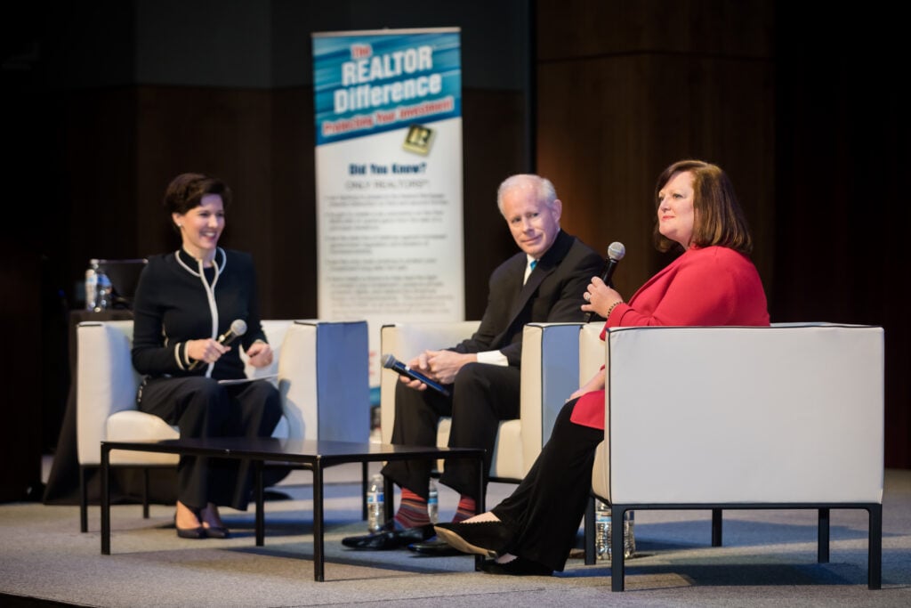 An image of three people on stage during a panel discussion at a corporate event photographed by Atlanta Corporate event photographer Karen Images