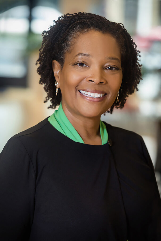 Professional corporate headshot of a businesswoman photographed in an environmental setting