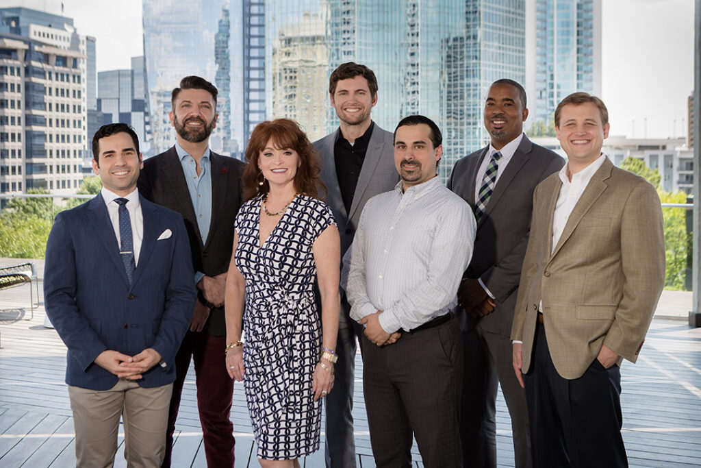 Corporate team portrait of six professionals photographed together in an Atlanta office environment