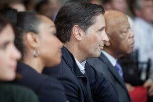 The honorable John Lewis sitting next to CEO of PCNA at One Porsche Drive in Atlanta