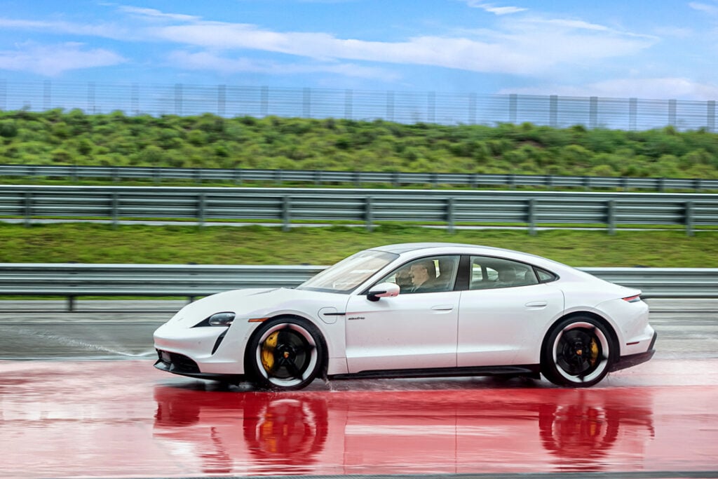 Image of people driving a Porsche Taycan on the track at One Porsche Drive during a corporate event photographed by Atlanta Commercial Photographer Karen Images
