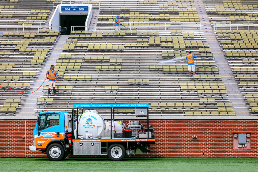 An image of a Wise Guys pressure washing truck on the field of Bobby Dodd Stadium in Atlanta Georgia by Atlanta Commercial Photographer Karen Images