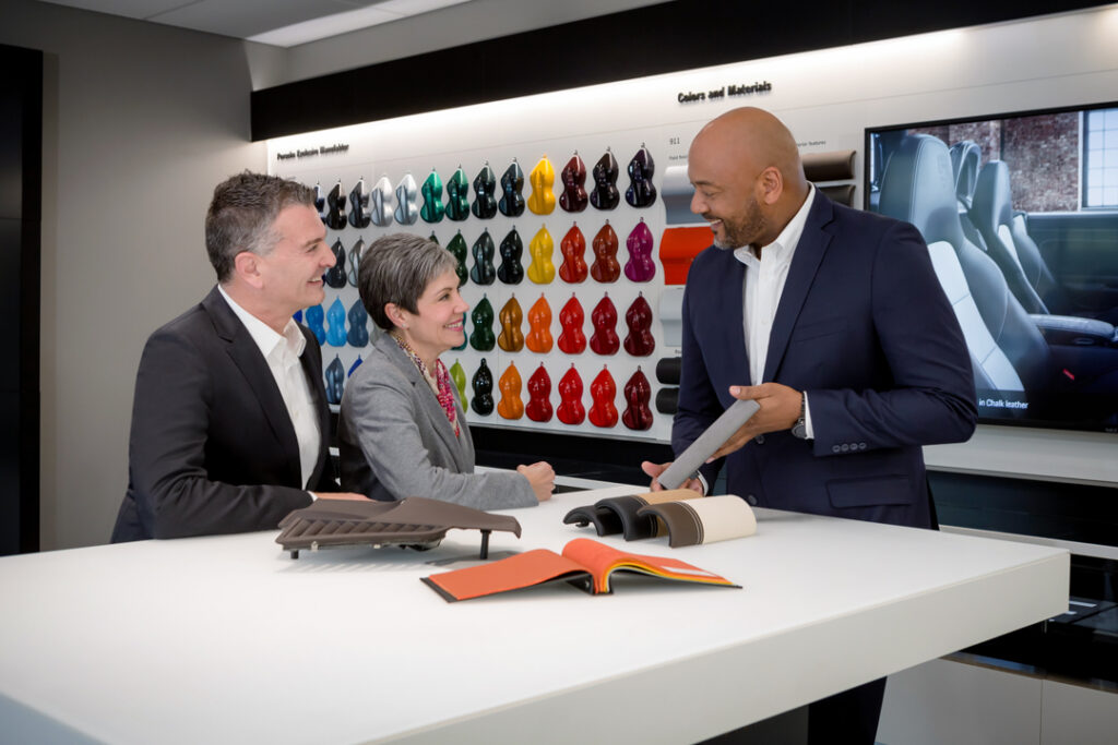 A custom stock image of an employee and customers in the Porsche Design center at One Porsche Drive in Atlanta Georgia by Atlanta Commercial Photographer Karen Images