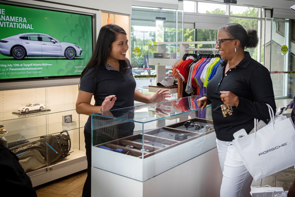 An image of women at a Top Golf gift shop during a corporate event sponsored by Porsche photographed by Atlanta Commercial Photographer Karen Images