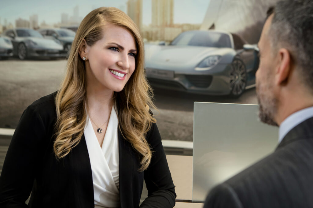 A custom corporate stock photography image of a woman serving a customer at one Porsche Drive by Atlanta Commercial Photographer Karen Images