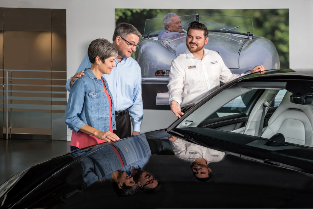 A corporate culture image of Porsche employee and customer during a new car delivery used in marketing and advertising photographed by Atlanta corporate photographer Karen Images
