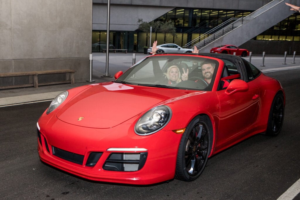 An image of people in a red 911 at a corporate event at One Porsche Drive photographed by Atlanta Corporate Event Photographer Karen Images