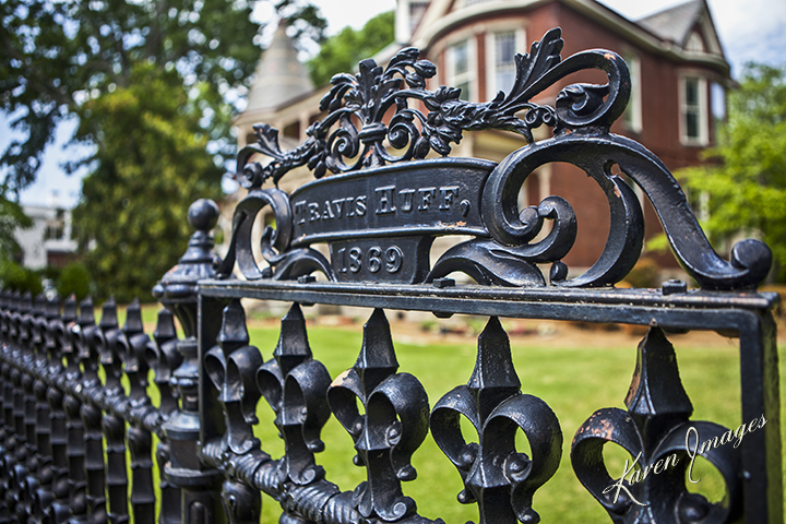 A color image of fine art photography of an iron fence in front of a Victorian mansion in College Park, Georgia photographed by Atlanta Fine Art Photographer Karen Images
