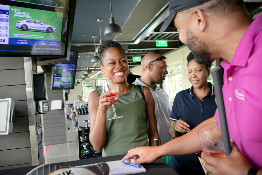 An image of contestants at a Top Golf corporate event hosted by Porsche photographed by Atlanta Corporate Event Photographer Karen Images