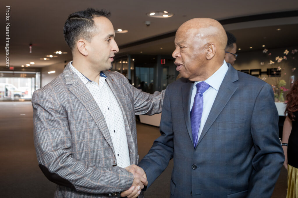An image of an employee shaking hands with the Honorable John Lewis at One Porsche Drive in Atlanta photographed by Atlanta Corporate Event Photographer Karen Images