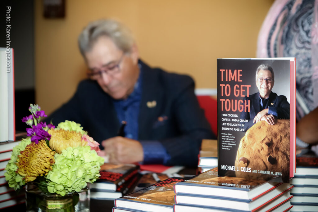 An image of an author at a book signing during a corporate event photographed by Atlanta Corporate Event Photographer Karen Images