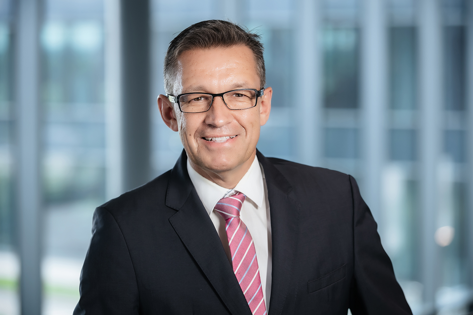 executive corporate headshot of an executive photographed on location at one porsche drive by corporate headshot photographer karen images