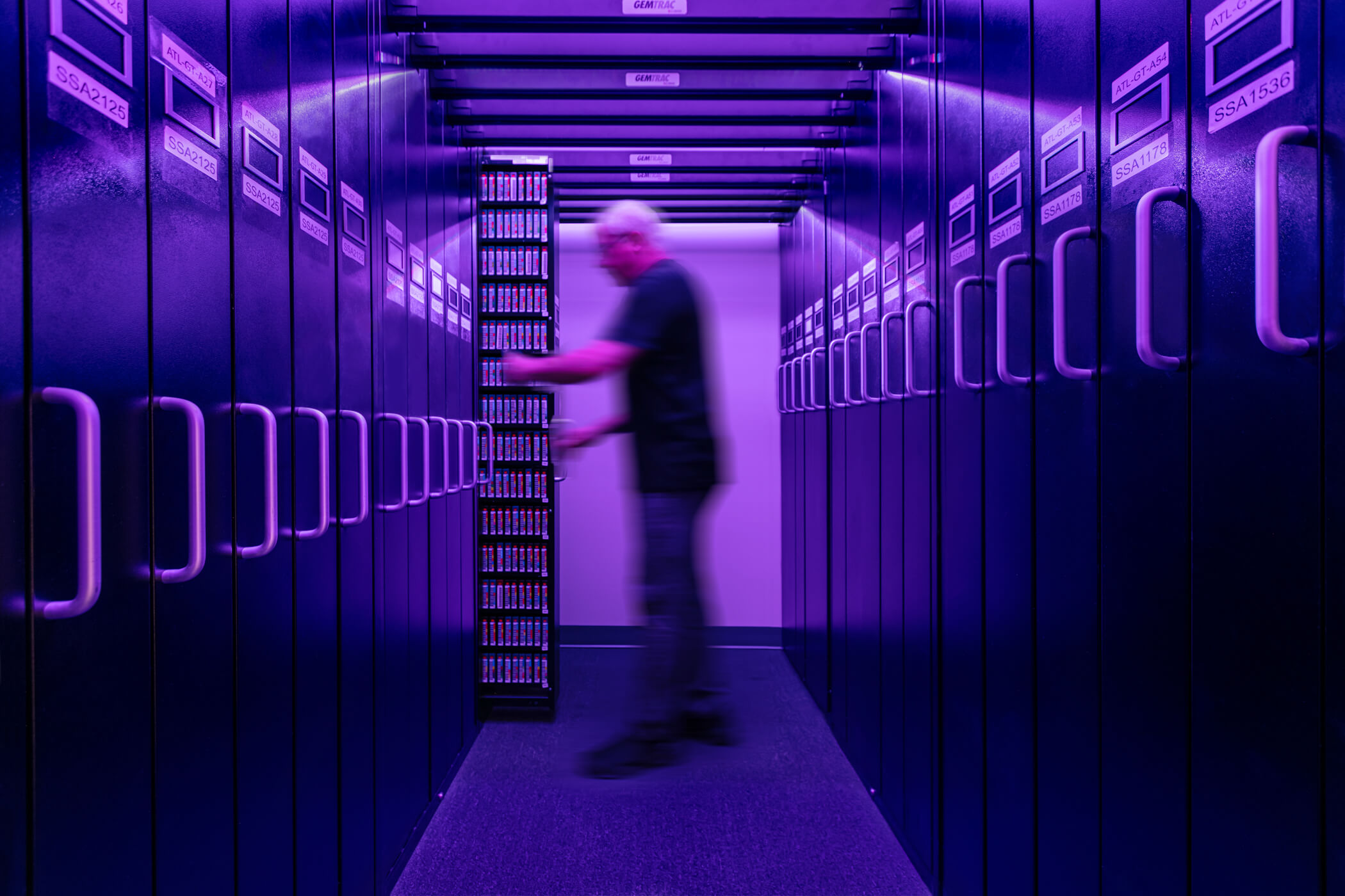 Technician working inside a magnetic tape storage center