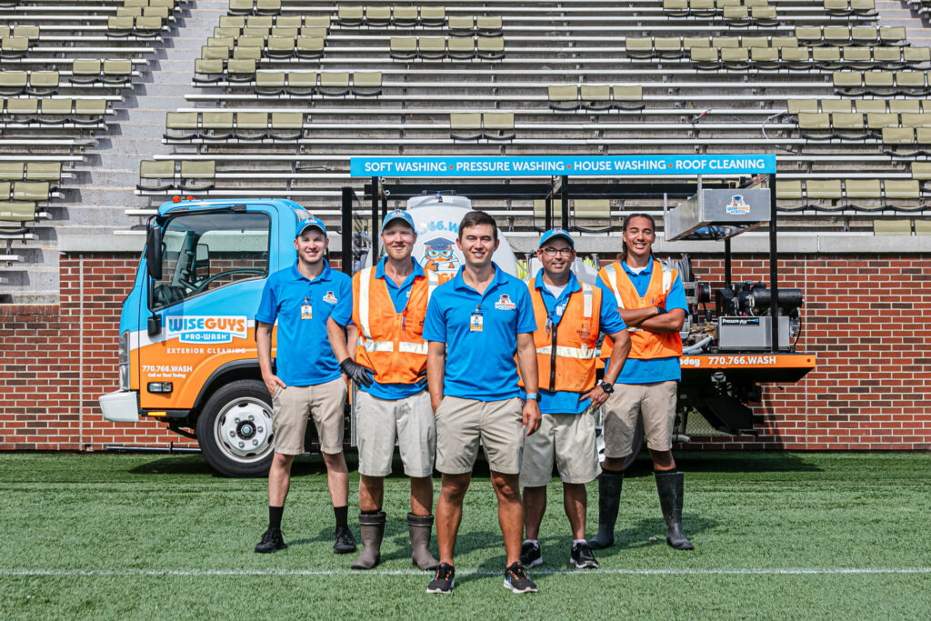 Industrial field crew gathered with company vehicles and equipment
