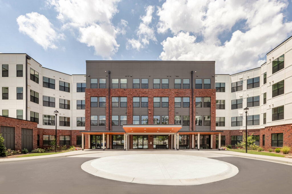 exterior facade of the veranda at assembly photographed on a sunny day a kitchen in a one bedroom model home at crofthouse photographed by architectural photographer karen images