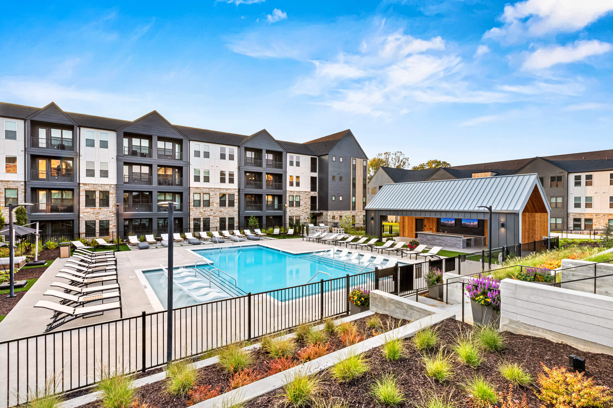 Multifamily residential development with swimming pool, landscaped courtyard and apartment buildings