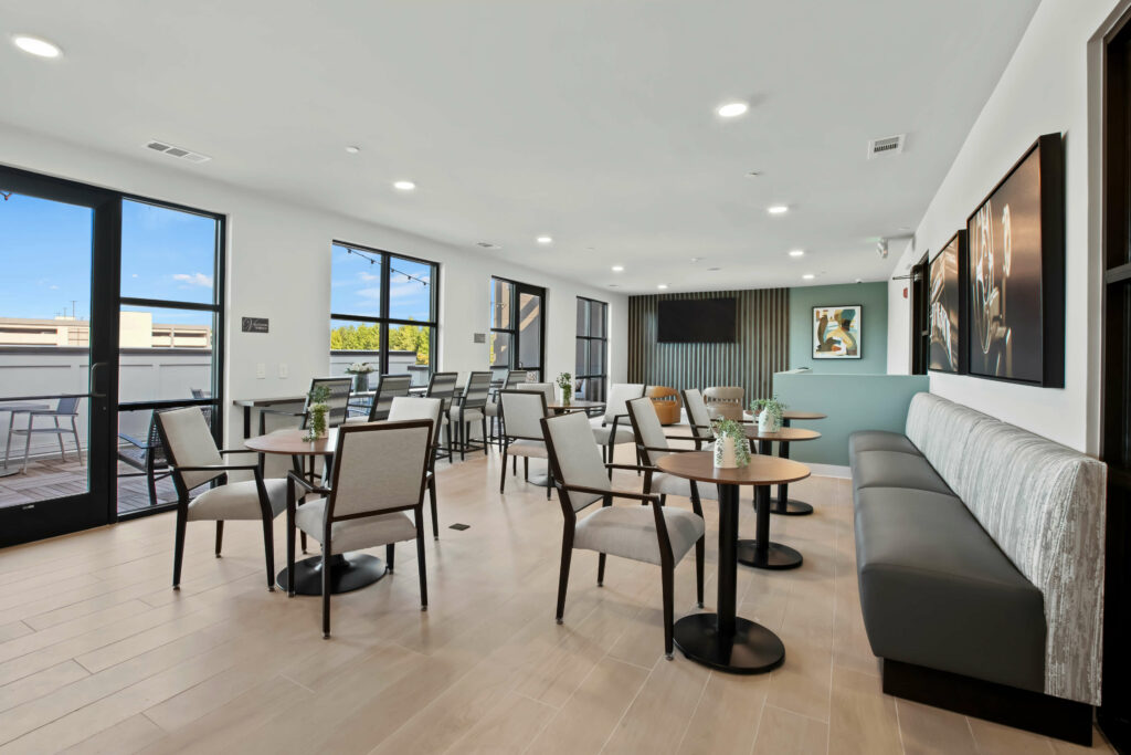 a community room at veranda at assembly a kitchen in a one bedroom model home at crofthouse photographed by architectural photographer karen images