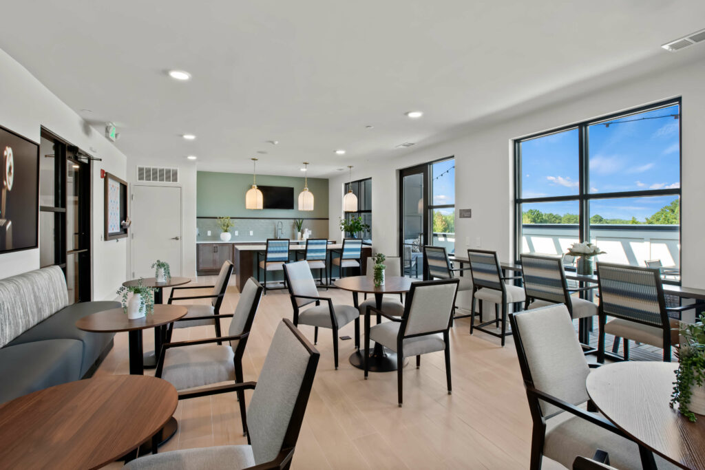 alternate view of a community room at veranda at assembly a kitchen in a one bedroom model home at crofthouse photographed by architectural photographer karen images