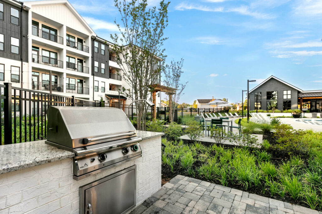 an outdoor grill near the pool of crofthouse photographed on a sunny day by architectural photographer karen images