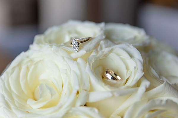 Bridal Bouquet
Wedding rings displayed on the bride's white rose bouquet