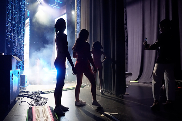 Miss America contestants silhouetted and waiting to go on stage