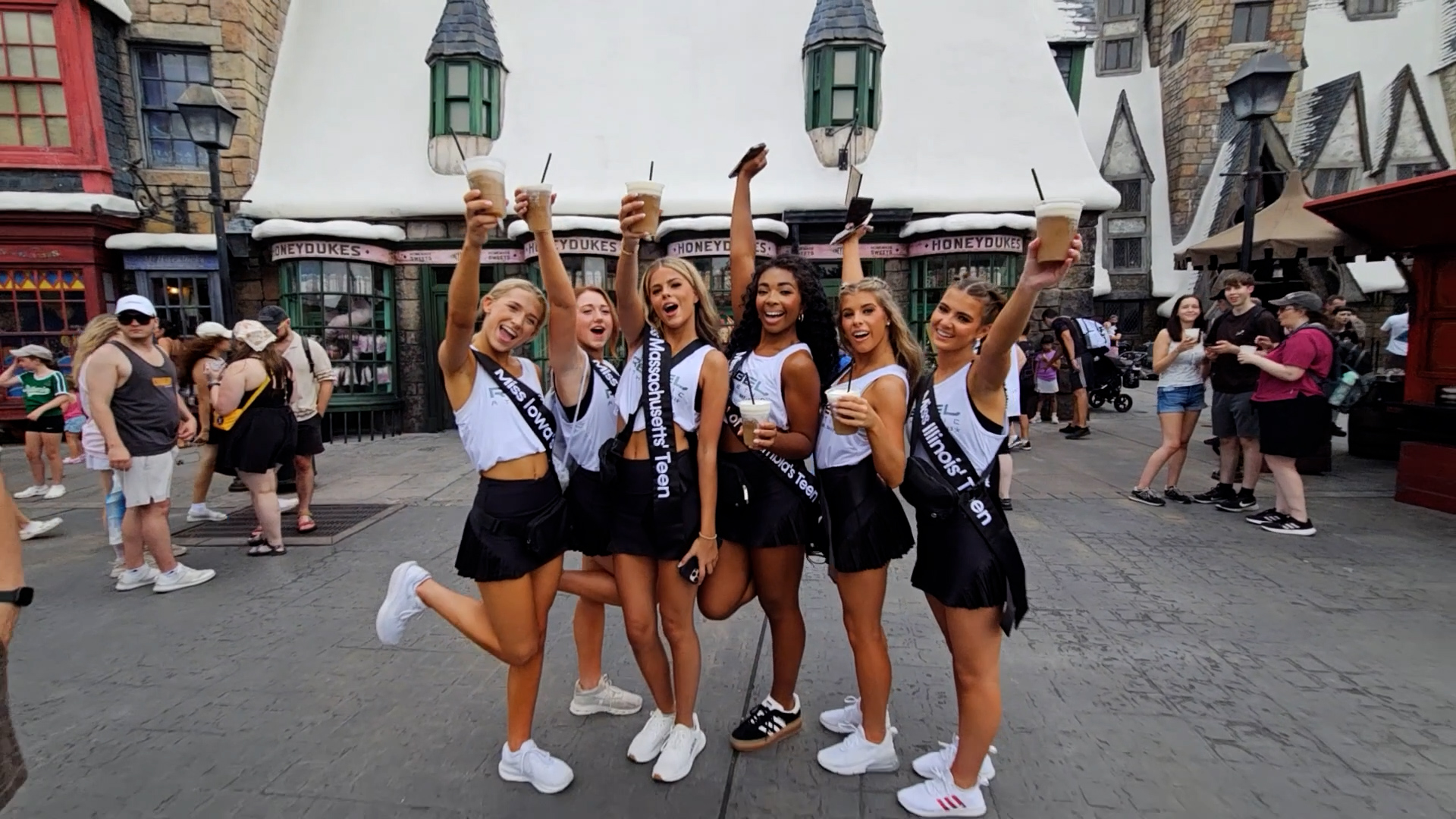 Miss America contestants celebrating together during a branded event