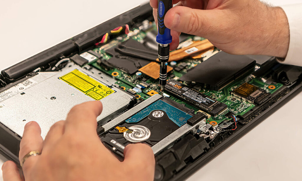 a technician remoes an SSD Drive for inspection at S2 Data by Karen Images