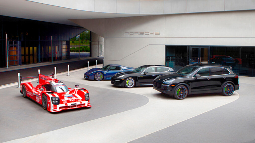 An image of a Porsche Le Mans race car with three current models on DVP Strasse at One Porsche Drive Atlanta Ga
