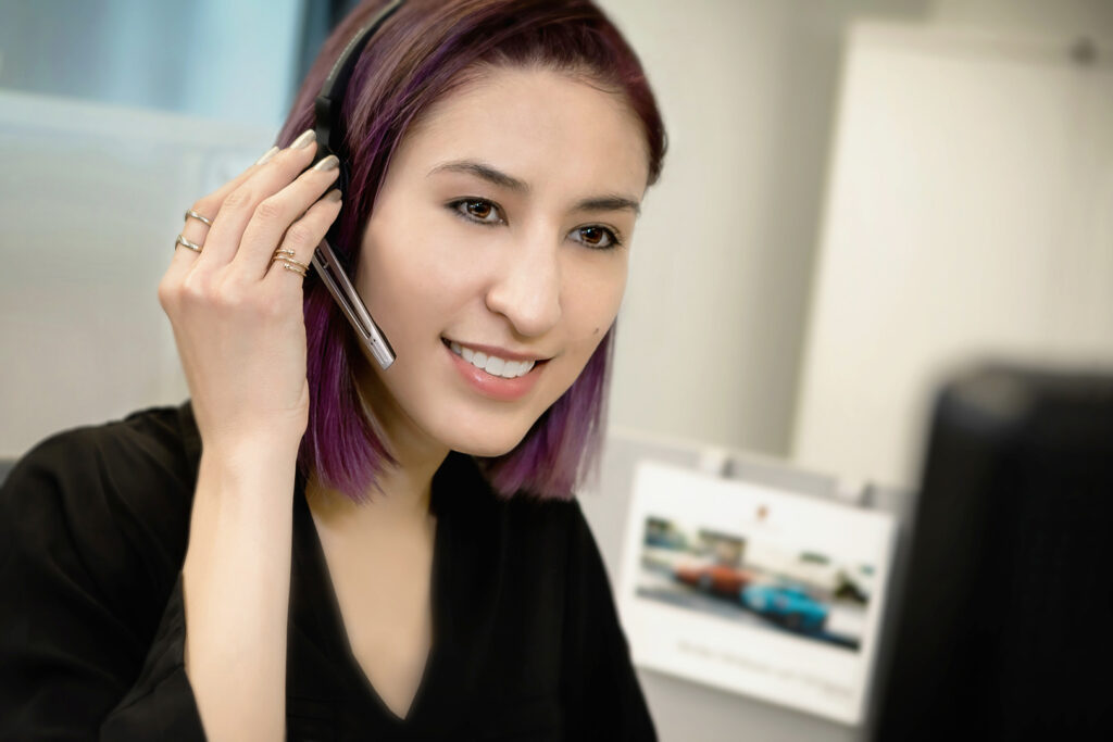 Porsche Cars North America female customer service representative answering a call from a Porsche owner