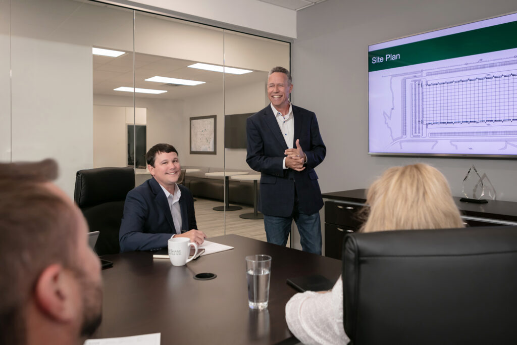 McShane executives in a conference room during a corporate culture photo session
