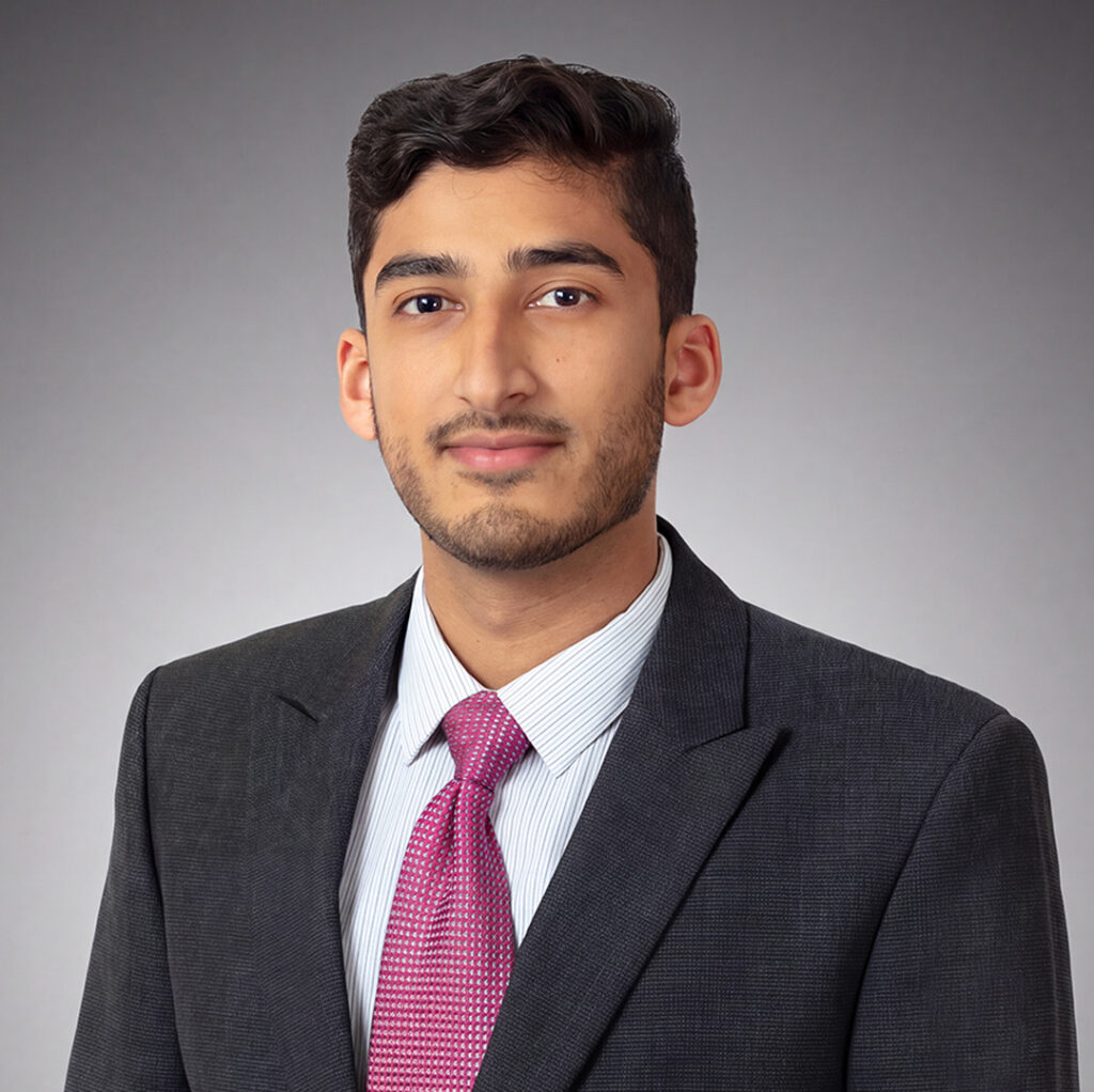 Corporate headshot of a man on a gray backlit background