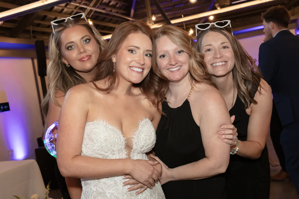 Bride celebrating with friends during her wedding reception at Limestone Hall in Lexington, Kentucky
