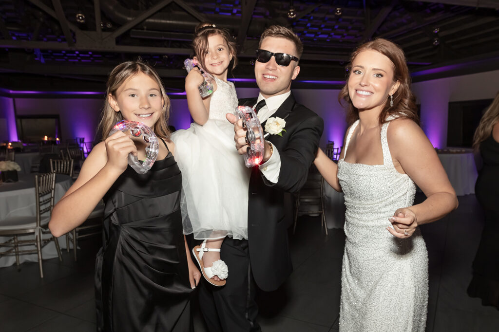 Bride and groom celebrating with friends during their wedding reception at Limestone Hall in Lexington, Kentucky
